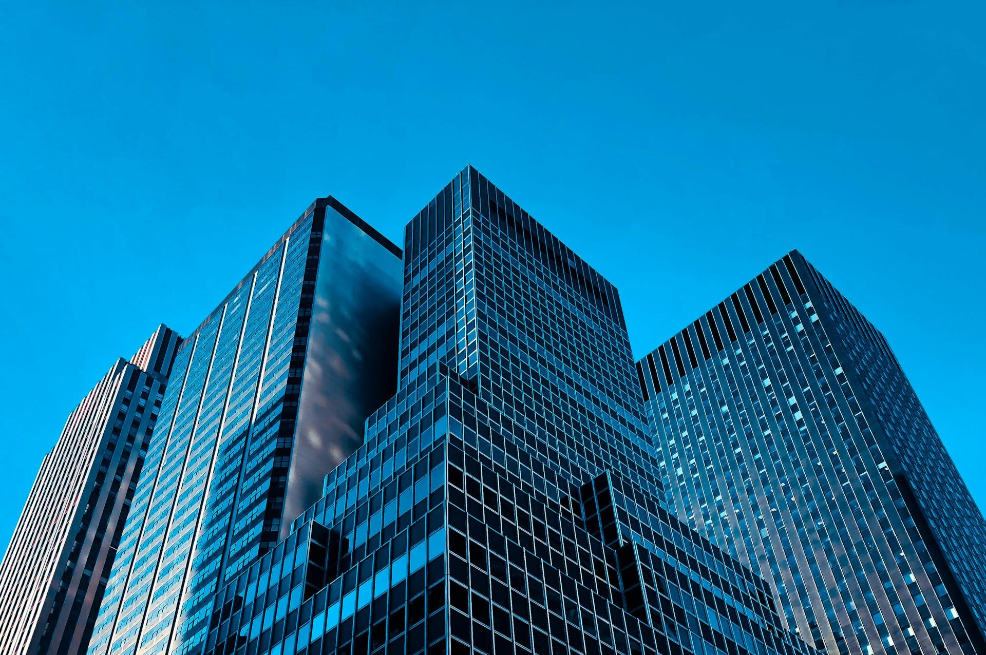 Corporate glass building against a clear blue sky